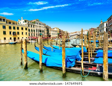 Venice grand canal, gondolas or gondole and Rialto bridge on background. Italy
