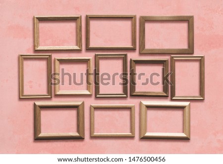 old wooden frames on pink wall