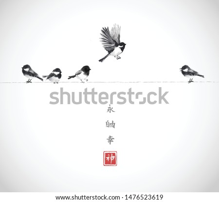 One bird flying and four little birds sitting on a wire. Traditional oriental ink painting sumi-e, u-sin, go-hua on white background. Hieroglyphs - eternity, freedom, happiness, spirit