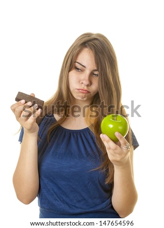 Teen with brownie and apple against a white background.