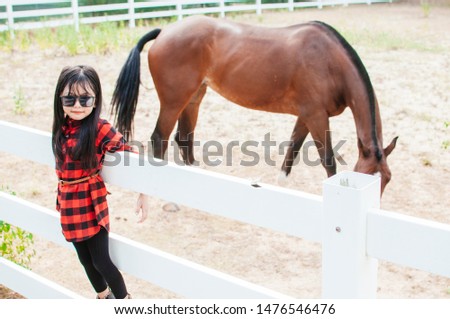 Little kids girl with horse
