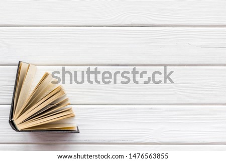 Books on library desk for reading and education on white wooden background top view mockup