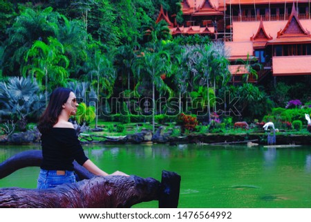A cute young woman sits admiring the nature of Khao Wong Temple, Uthai Thani Province, Thailand