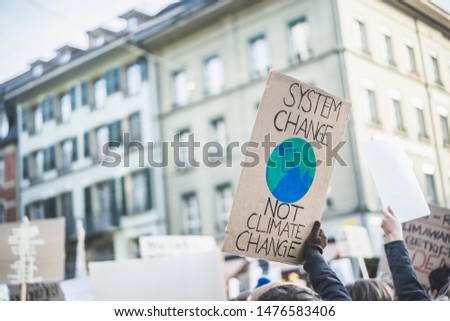 Group of demonstrators fight for climate change - Global warming and enviroment concept - Focus on banner