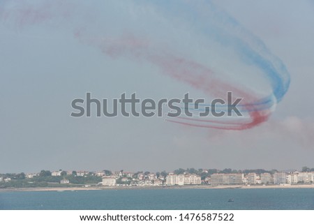 Acrobatic demonstration of the Patrouille de France (PAF) in the seaside town of Saint-Jean-de-Luz, France