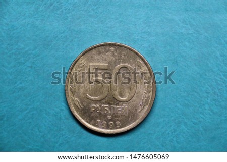 
Round coins of the world on a plain background
