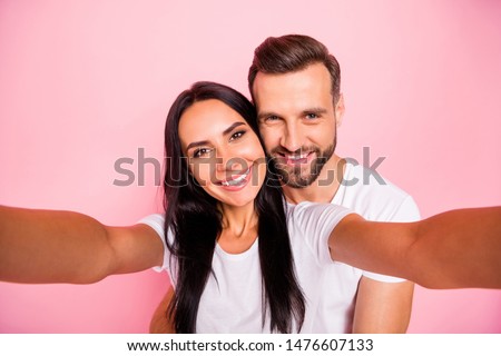 Photo of nice couple with man hugging his beloved girlfriend from back while isolated with pastel background