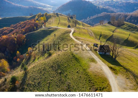 Autumn aerial shot of a ranch, homestead in Apuseni mountains. Drone view of rural place in Transylvania, Romania Royalty-Free Stock Photo #1476611471