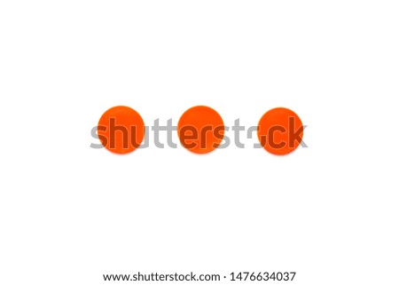 Three orange round shapes isolated on white background. Top view, flat lay composition.