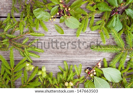 Christmas wooden background is green fir-tree branches
