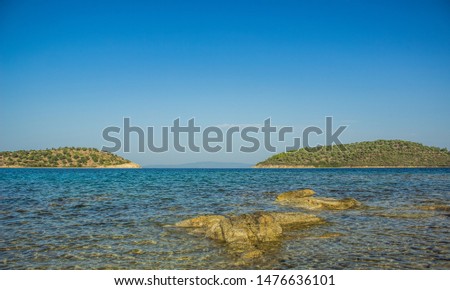 Mediterranean sea shallow water lagoon nature scenic view with two islands on background 