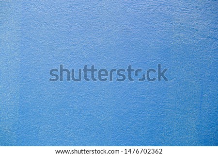 Fine plaster painted wall blue colortexture.
