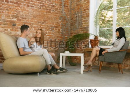 Couple in therapy or marriage counseling. Psychologist, counselor, therapist or relationship consultant giving advice. Man and woman sitting on a psychotherapy session. Family, mental health concept.