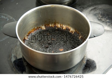 Empty burnt pot with black bottom Royalty-Free Stock Photo #1476726425