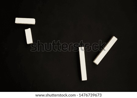 school white crayons on a black graphite background, minimalism, space for text