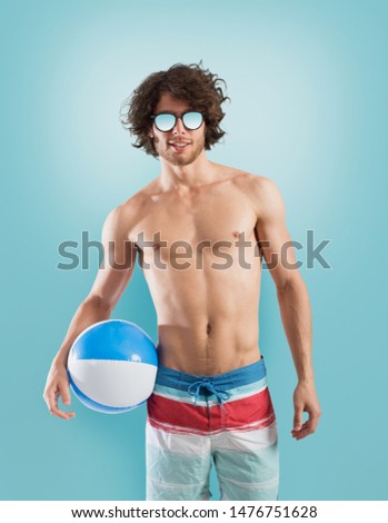 Boy with swimsuit on light blue background