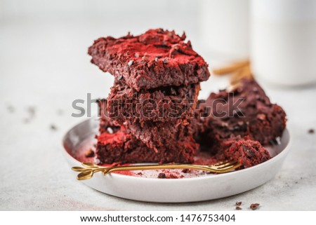 Beetroot vegan brownie on gray plate. Healthy vegan food concept.