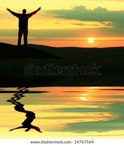 Happy man silhouette on the lakes coast
