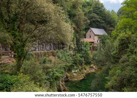 Cabrales cheese museum next to the Cares river Royalty-Free Stock Photo #1476757550