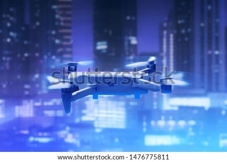 Drone quadcopter with digital camera above city
