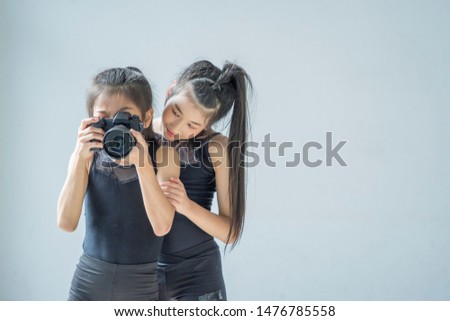 The girl is training to take pictures in the studio.