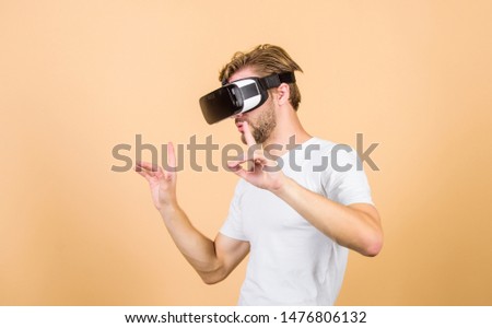 Virtual simulation. Man play game in VR glasses. Augmented 3D world. Explore cyber space. Man hipster virtual reality headset on peach background. Entertainment and education. Virtual communication.
