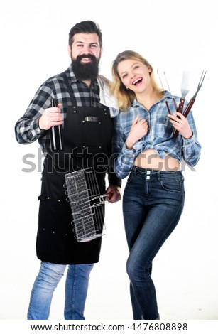 Picnic and barbecue. Bearded hipster and girl ready for barbecue party. Roasting and grilling food. Cooking together. Couple in love hold cooking utensils barbecue. Tools for roasting meat outdoors.