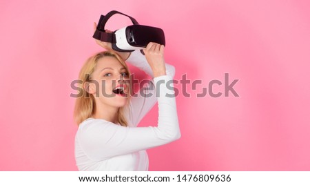 Cheerful smiling woman looking in VR glasses. Woman with virtual reality headset. Woman enjoying cyber fun experience in vr. E-sports