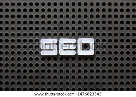 Black color pegboard with white letter in word SEO (Abbreviation of search engine optimization)