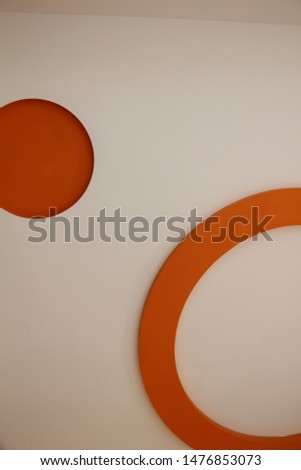 Illustrations of orange circles on a white wall