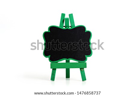 Black wooden chalkboard on tripod easel isolated on white background.