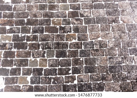 Texture of brick floor with snow on the street at the Red square in Moscow, Russia