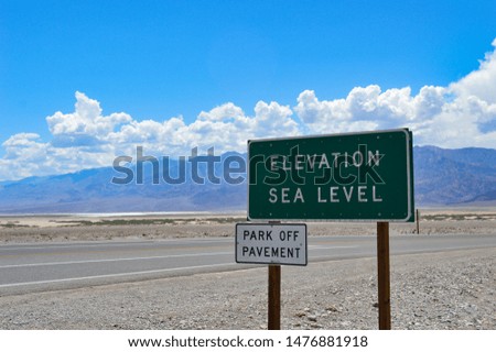 "ELEVATION SEA LEVEL" sign in Death Valley National Park, CA in front of a beautiful landscape