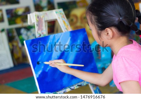 Asian girls are learning the art of drawing , art as an important part in brain development.