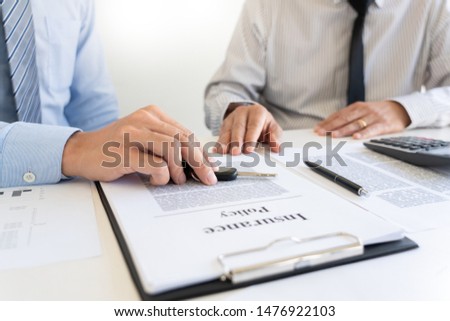 business man agent offer insurance form clipped to pad and silver pen to sign closeup. Certificate of motor insurance and policy schedule with car key, consultant signing car  contract.