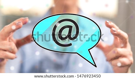 E-mail concept between hands of a woman in background