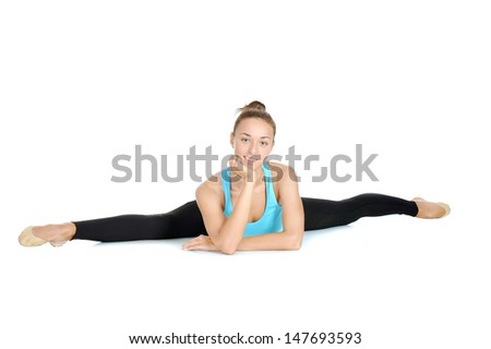 athletic girl in a blue t-shirt doing exercise on a white background