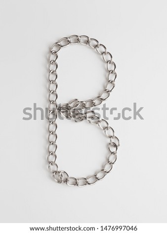 shining letter B woven from a chain on a white background
