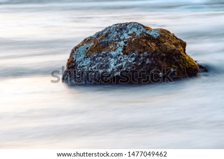 Long exposure photo of a stone in the river
