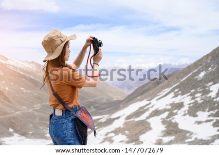 Portrait of young Asian woman talking photos on snow mountain, outdoors and traveller concept