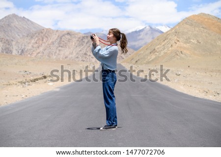 Portrait of young Asian woman talking photos on road in Ladakh. outdoors and traveller concept