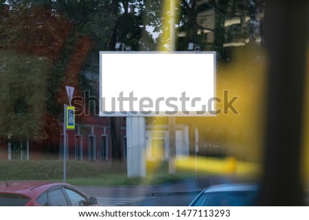 large billboard in the city mockup blurred foreground with yellow spots through the window