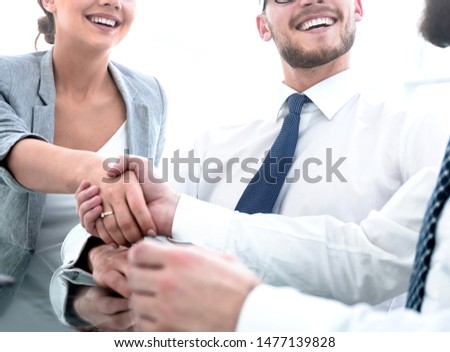 background image.handshakes colleagues at the Desk