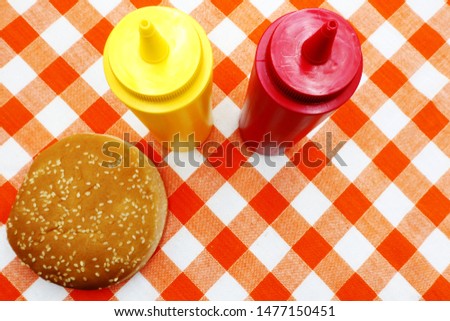 Hamburger Bun with sesame on tablecloth