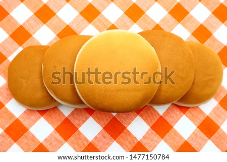 Hamburger Buns without sesame  on tablecloth