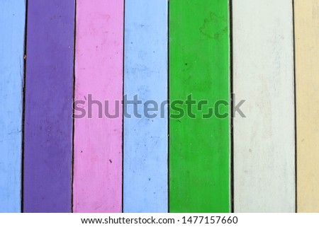 The colorful pastel colors of the virtical wood plank wall, background