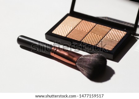 Makeup brushes and powder on a light background. Horizontal template for make-up artist business card or flyer design.