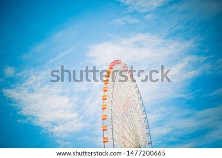Orange Ferris Wheel Moves in Clear Sky