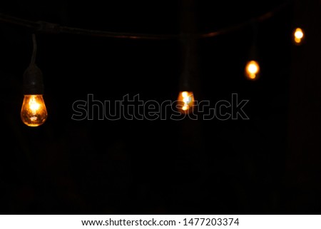 Light bulbs in the darkness Royalty-Free Stock Photo #1477203374