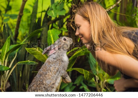 Woman holding a rabbit. Cosmetics test on rabbit animal. Cruelty free and stop animal abuse concept Royalty-Free Stock Photo #1477206446